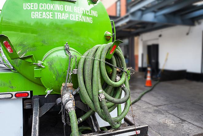 a grease trap pumping truck at a restaurant in Center Hill, FL